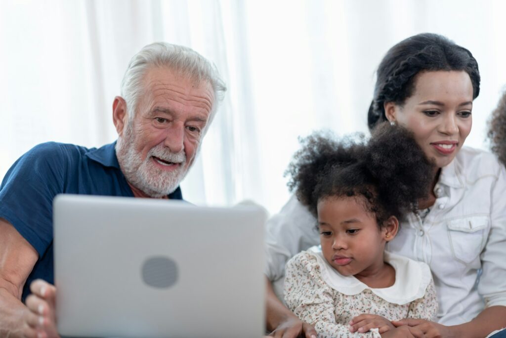 A happy family, grandfather, father, mother and daughter.